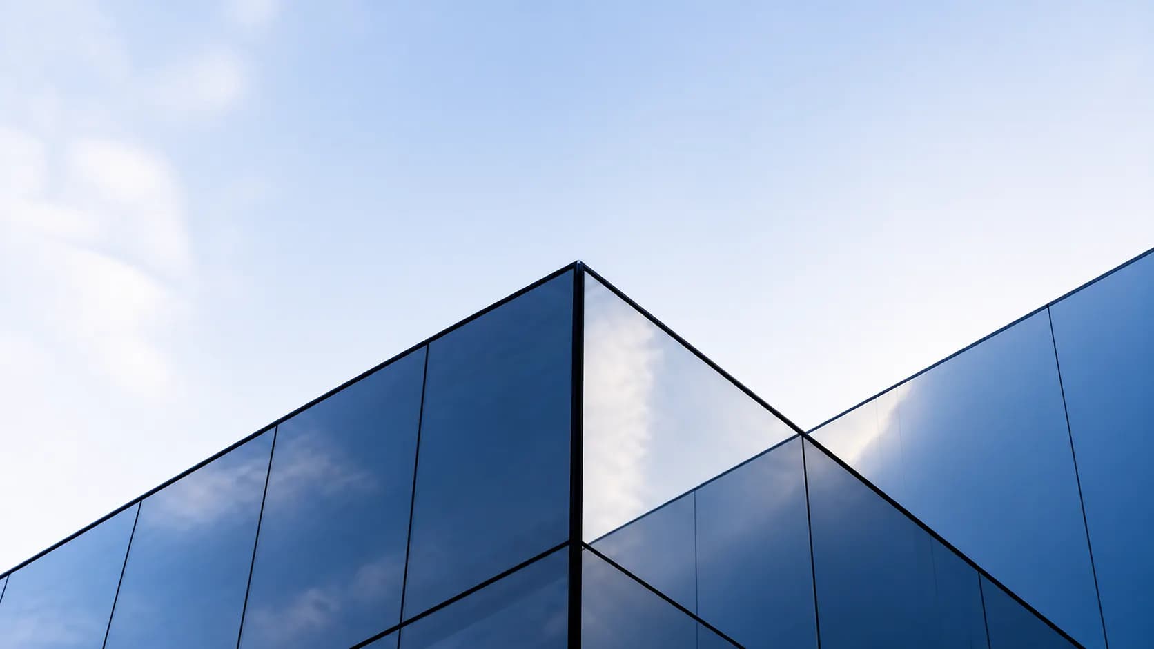 Low-angle view of a modern blue-glass business building